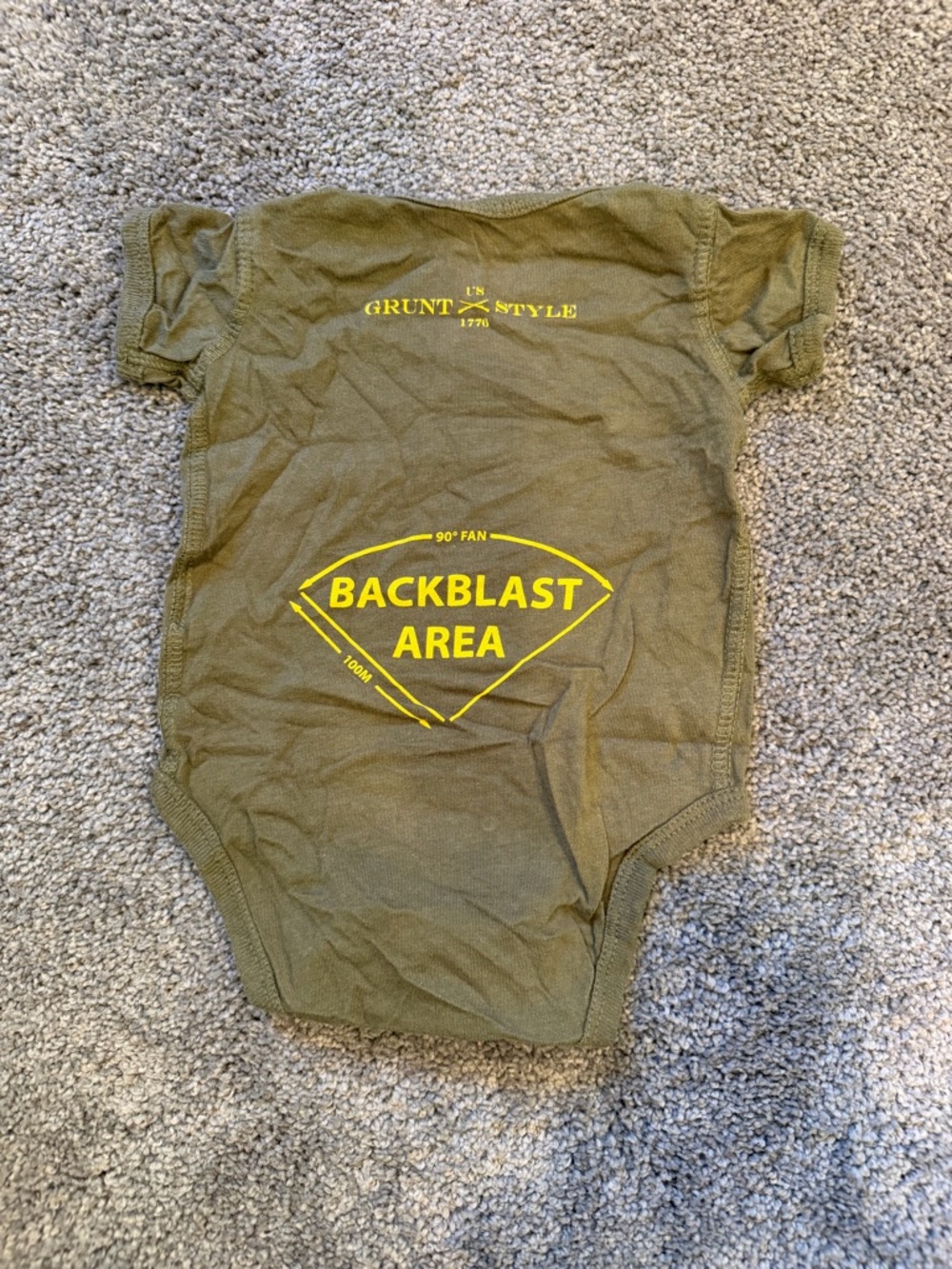 Grunt Style Olive Green Onesie with Yellow Backblast Graphic